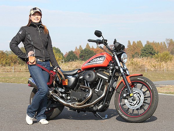 バイク乗りのウェアは、大きく分けると「バイク専用にデザインされたウェア」と「タウンユースがメインのウェア」。そりゃあ安全性や動きやすさという点で言えば、文句ナシにバイク専用ウェアに軍配が上がります。どちらを選択するかはそれぞれの好みや考え方によるけど、バイク専用ウェアって昔に比べればまだマシになったものの、ファッション業界から見ればまだまだ。どちらも同じアパレル業ですが、ファッションと呼べるか？は疑問です。前置きが長くなりましたが、トモカさんのファッションを見ていて、アウターのサイズが若干大きいようなブラックカラーよりアースカラーやパステルカラーなんかだと女性らしさも演出できるし、オレンジカラーの愛車とも合うんじゃないのかな？と思った次第です。